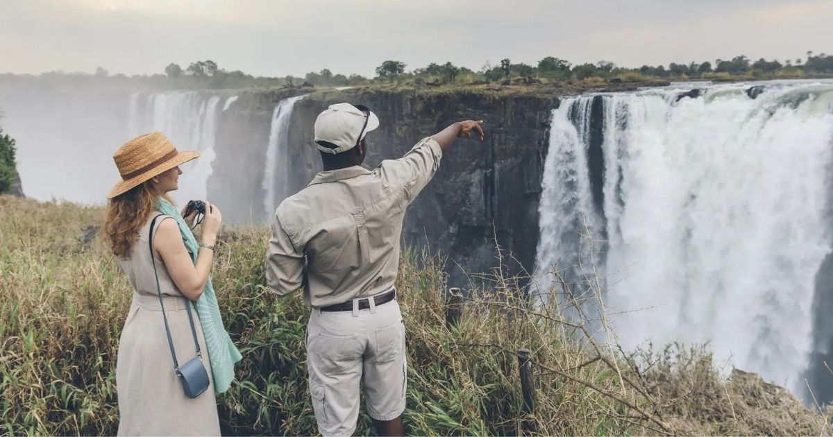 Is Zimbabwe Safe for Tourists? A Complete Travel Safety Guide 2 Image of a tourist with a guide at the Victoria Falls
